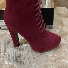 A Platform Bootie With Adjustable Laces. Material: Faux-Suede Features: Sd Dream Sole - Double The Padding For Comfort, Support, And Ease Of Movement Platform Height: 0.79" Outside Heel Height: 4.9" Closure: Adjustable Laces Shaft Height: 7.2" Imported Fit: True To Size Burgundy Heels With Round Toe, Burgundy Lace-up Heels, Fall Suede Heels With Red Sole, Red Suede Heels For Winter, Red Suede Ankle-high Heels, Burgundy Suede Closed Toe Heels, Red High Heel Boots, Just Fab Shoes, Maroon Red