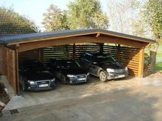 three cars are parked in an attached carport