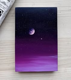 an acrylic painting of the moon and stars on a purple background with some paint next to it