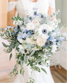 a bridal holding a bouquet of white and blue flowers