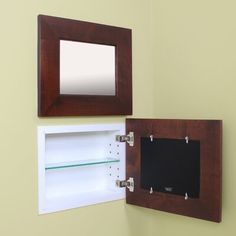 two mirrors mounted to the side of a wall