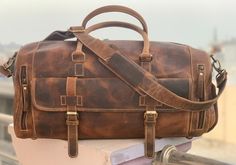 Upgrade your travel style with our luxurious exotic brown leather weekender bag. Perfect for jetsetters who value both fashion and function. • Free shipping all over the World. • Size: 20 X 9.5 X 10.5 inches (Width X Height X Depth) • Material: Genuine Cowhide Leather. • Cotton Lining. • Metal studs. • Closure : Full zipper closure. YKK zippers. • Model features: comes with one inner zipper pocket, 2 outer zipper pocket and one big pocket outside with buckle closure. • Shoe compartment. • Access Cowhide Purse, Leather Weekender Bag, Leather Weekender, Frequent Traveler, Leather Travel Bag, Big Pocket, Model Features, Leather Travel, Weekender Bag