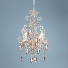 a white chandelier hanging from a ceiling