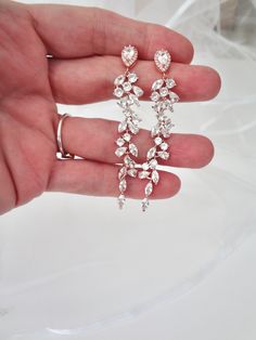 a person is holding some jewelry in their hand and it looks like they're getting married