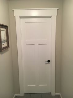 a white door is in the corner of a room