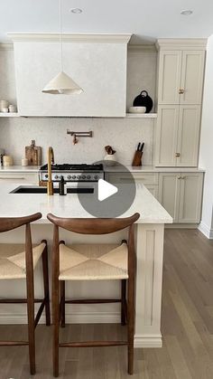 a kitchen with two chairs and an island