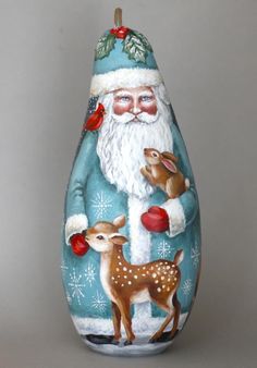 an egg with santa claus and deer painted on it