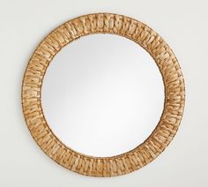 a round mirror made out of woven wicker