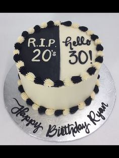 a white and black birthday cake with the number 20 on it