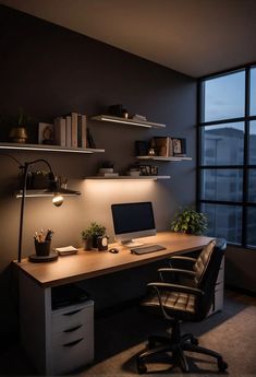 a desk with a computer on it in front of a window and some bookshelves