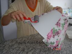 a woman cutting paper with a pair of scissors