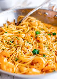 pasta with shrimp and parsley in a skillet, ready to be eaten by someone