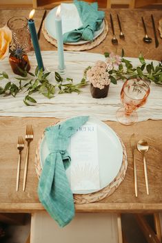 a table set with place settings and napkins