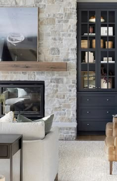 a living room filled with furniture and a fire place next to a wall mounted tv