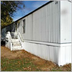 an old white building with steps leading up to it