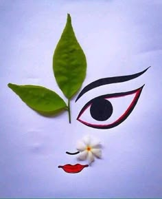 the face of a woman with green leaves on her forehead and white flowers in front of it