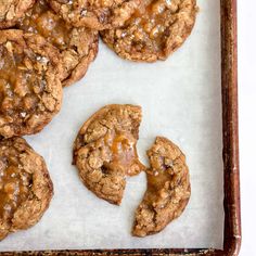 chocolate chip cookies with caramel drizzled on top in a baking pan