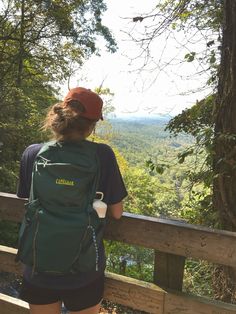 a woman with a backpack looking at the view