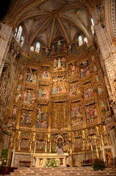 the interior of an ornate church with gold and white decorations