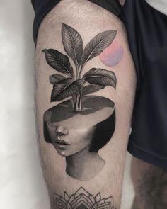 a man's leg with a tattoo on it and a plant growing out of his head