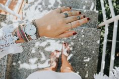 a woman's hand with two rings on her wrist