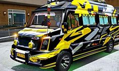 a yellow and black bus parked in front of a building