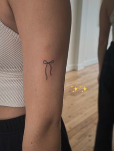 a woman's arm with a tattoo on it and three stars in the background