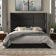 a bedroom with a large bed and two paintings on the wall above it's headboard