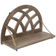 an old wooden shelf with rope hanging from it