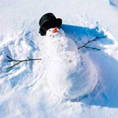 a snowman is standing in the middle of some deep snow and has his head turned to look like he's wearing a black hat