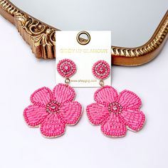 There is hanging beaded flower pendant from the gold stud earrings. The flower pendants are pink with  gold outline and detailing. These earrings are pictured in front of a gold mirror on a white background. Embroidery Jewellery, Beaded Flower Earrings, Embroidery Earrings, Seed Bead Bracelet Patterns, Glamour Style, Handmade Clay Jewelry, Giddy Up Glamour, Bead Embroidery Jewelry, Pink Vibes