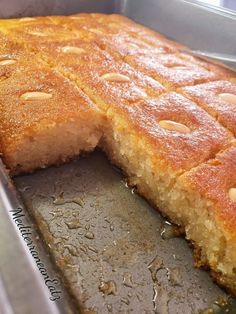 a close up of a cake in a pan with one slice cut out and the other half eaten