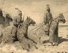 two men riding on the backs of horses in native clothing, one wearing a headdress