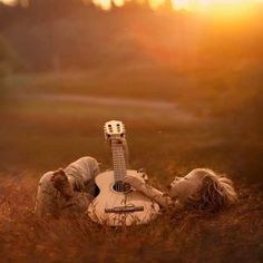 a person laying on the ground with a guitar