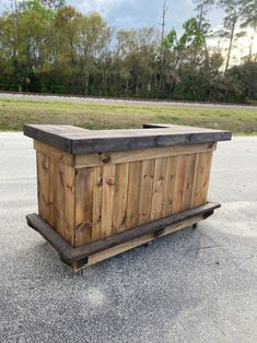 a large wooden box sitting on top of a parking lot