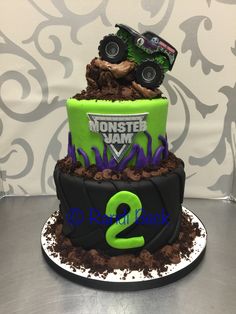 a monster truck birthday cake with green and black frosting on it's top