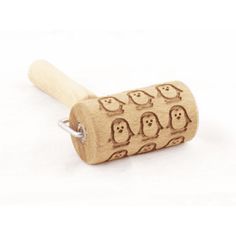 a wooden rolling pin with penguins on it