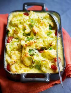 a casserole dish with broccoli and tomatoes