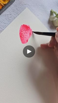 someone is using a marker to draw a heart on paper with watercolor pencils