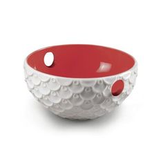 a red and white bowl with holes in the center on a white background, it is also used for serving food