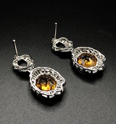 HUGE 15.90 Carats, Thai yellow sapphires and 3.22 carats of F/VS, natural diamonds, set in handmade 16 grams, 18K solid white gold earrings. ONE OF A KIND HANDCRAFTED EARRINGS. IN CASE OF RETURN FOR US BUYERS. BUYERS MAY SEND THE ITEMS BACK TO OUR US-BASED OFFICE IN SALT LAKE CITY, UTAH Our jewelry are specially designed, and are delicately handcrafted by local Thai, professional goldsmiths, who have had decades of experience in creating fine jewelry. SUGGESTED RETAIL VALUE: 12,000 THE ITEM YOU Formal Orange Teardrop Earrings, Elegant Orange Earrings For Formal Occasions, Orange Teardrop Earrings For Formal Occasions, Formal Topaz Earrings With Prong Setting, Formal Topaz Earrings, Formal Orange Gemstone Earrings, Orange Dangle Earrings For Formal Occasions, Orange Drop Earrings For Formal Occasions, Formal Topaz Drop Earrings