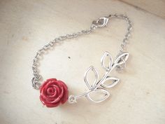 "Red Rose Silver Branch Bracelet A carved red rose is connected to a silver leaf branch and two lengths of chain. The leaf branch measures approx. 1 3/4\" and the rose is 15 mm or 1/2 in size. A nice pretty life like bracelet to wear. Bracelet measures 7\", if you'd like a different length just select your length at checkout. Bracelet is made with a lobster clasp. Your bracelet will come in a gift box and bow ready for gift giving. Enter back into store: rhondastreasures.etsy.com RhondasTreasure Whale Tail Jewelry, Branch Bracelet, Mustard Seed Jewelry, Mustard Seed Necklace, Dragonfly Bracelet, Pretty Life, Faith Necklace, Summer Bracelet, Blue Beaded Bracelets