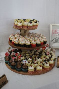 an assortment of cupcakes displayed on a table