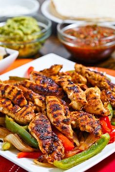 chicken fajita with peppers, onions and guacamole on the side