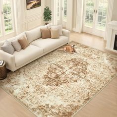 a dog is laying on the floor in front of a large area rug with an ornate design