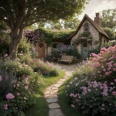 a stone path leading to a house with flowers growing on the roof and around it