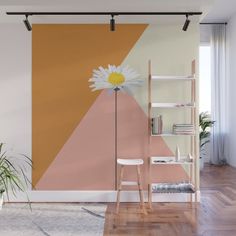 a wall mural with a flower in the center and an orange, pink, yellow and white geometric design