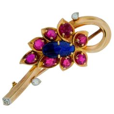 Adorable colorful pin created by Cartier in London in the 1950's. Inspired by floral motifs. Feminine and gracious. Features a carved sapphire surrounded with faceted rubies and accented with three diamonds set in 14k yellow gold. The pin is 1-7/8" long and 3/4" wide.The diamonds are set in white gold which accentuates their whiteness. The pin needle is made of rose gold.The brooch comes in the original fitted box. Gold Brooch, Antique Brooches, Gold Brooches, Fabulous Jewelry, Antique Diamond, Gold Flower, Ruby Diamond, Flower Pins, Vintage Brooch