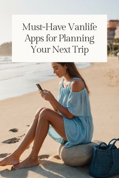 a woman sitting on the beach looking at her phone and texting must - have vanity apps for planning your next trip