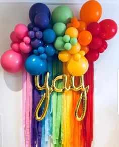 there are balloons that say yay on the wall